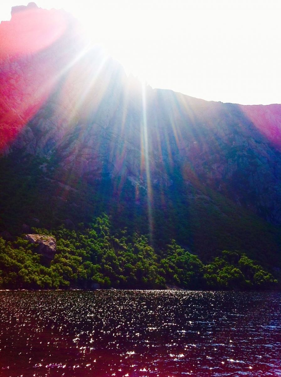 Multi-coloured sunlight on the ocean Sunlight creating blue and pink rays shining over the ocean