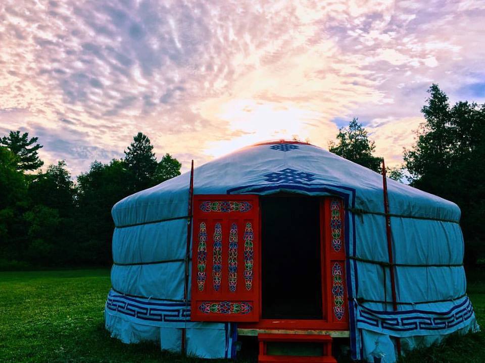Yurt at Deva Gardens  Yurt with a red door at sunrise