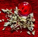 Crystal ball on a table with white sage around on a red background