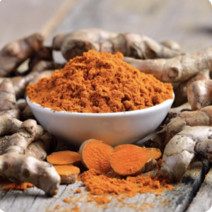 Yellow-orange turmeric ready to use in  a cup of golden milk.