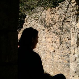 A woman in repose looking sad.